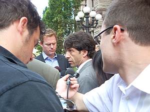 Lon Rose surrounded by reporters...